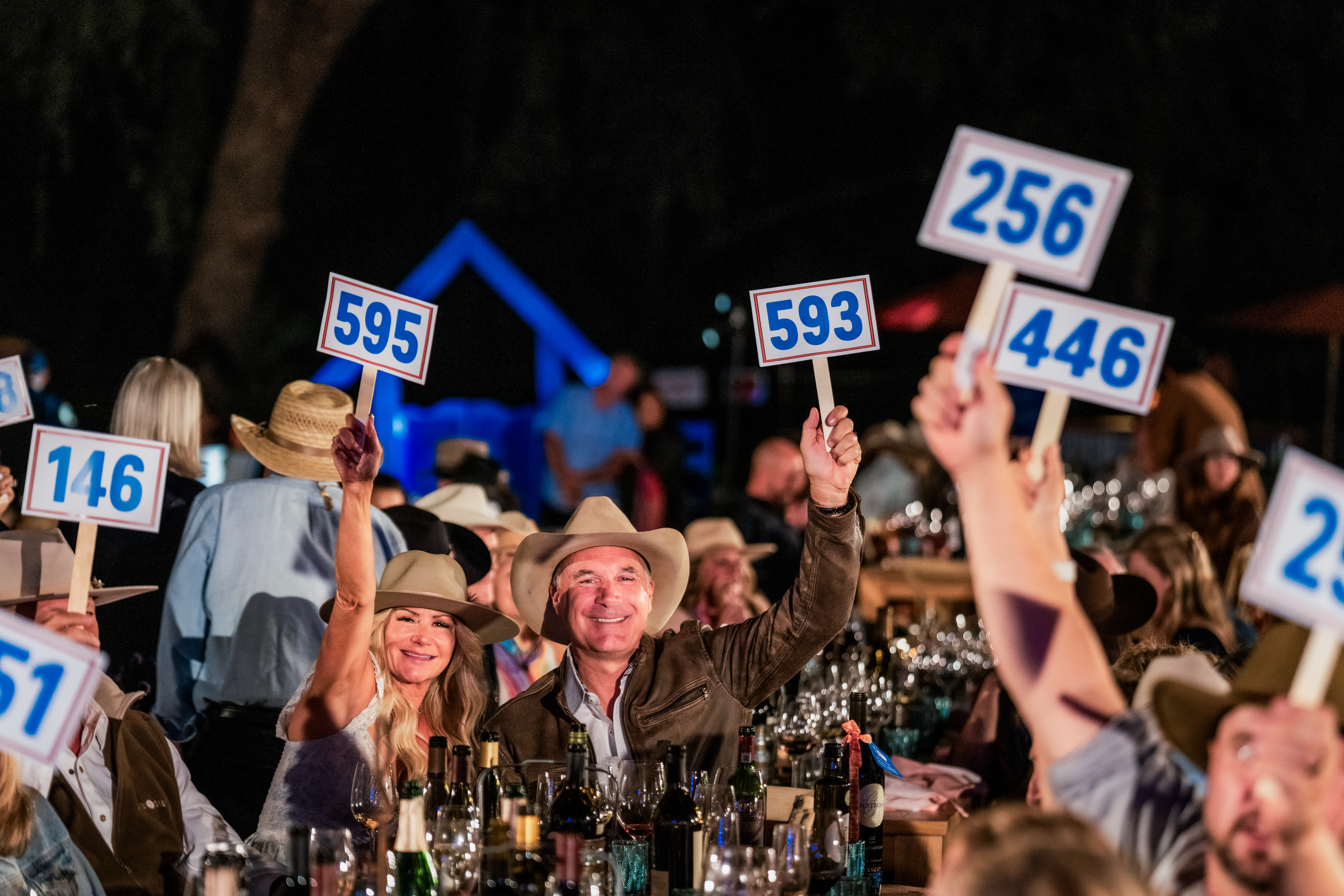 Image of John and Michele Truchard speaking on stage at the Harvest STOMP philanthropic community event in Napa Valley.